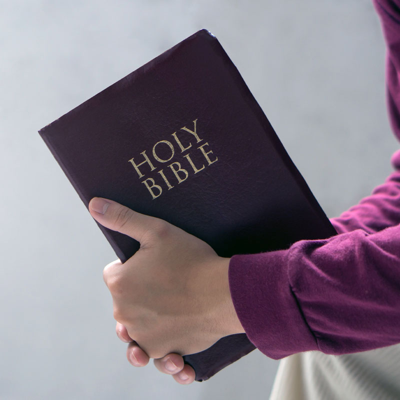 Bible concept. Man reading bible and praying to god