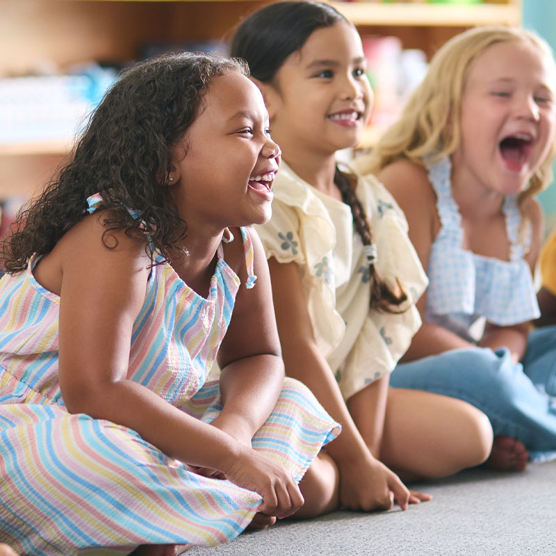 Kids sitting on the floor listening to the lesson