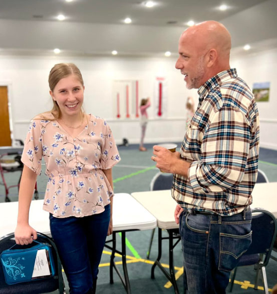 Youth leader talking to youth girl
