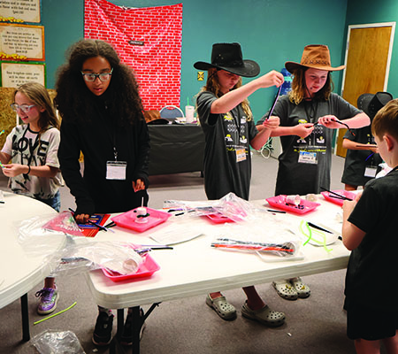 Older kids doing crafts while at Trinity Baptist Church's VBS in Lakeland, FL.