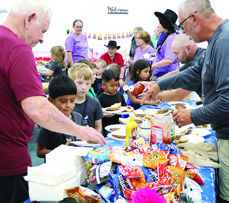 Volunteers serving dinner while at Trinity Baptist Church's VBS in Lakeland, FL.