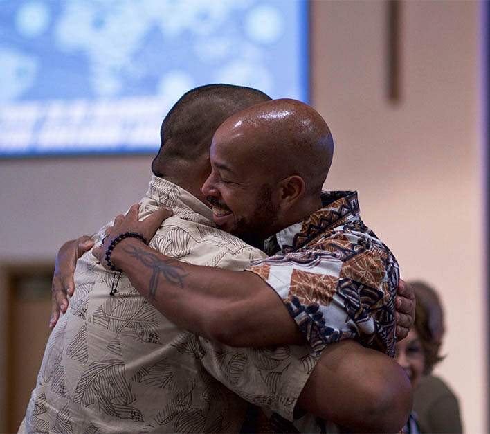 Two people hugging and smiling