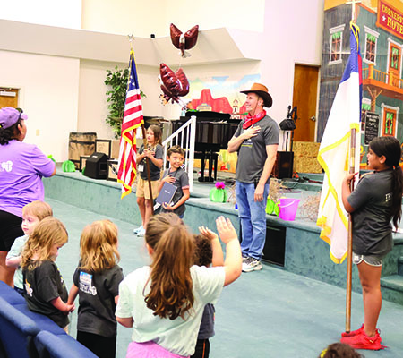 Kids holding the flags and bible for pledge time while at Trinity Baptist Church's VBS in Lakeland, FL.