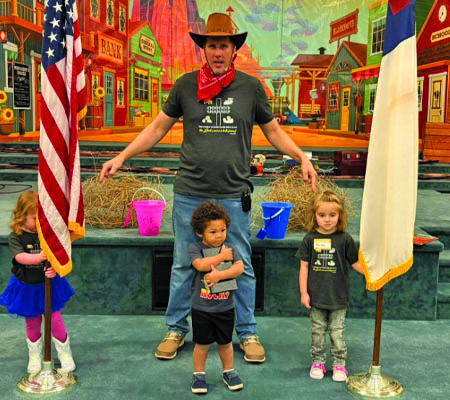 Kids holding the flags and bible for pledge time while at Trinity Baptist Church's VBS in Lakeland, FL.