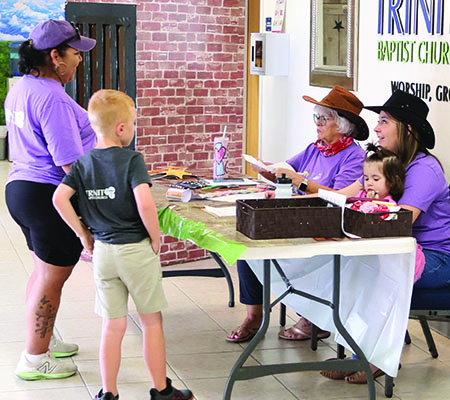 Parents checking in their kids while at Trinity Baptist Church's VBS in Lakeland, FL.